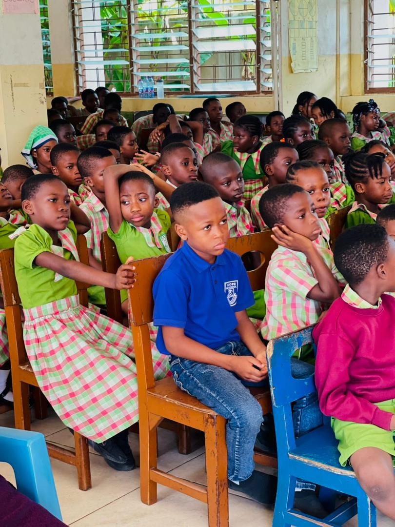 Kindergarten and Primary learners seated in a classroom assembly